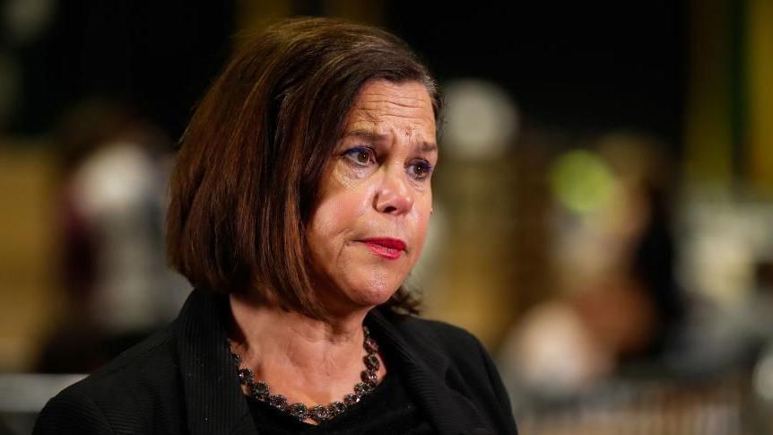 Mary Lou McDonald is wearing a black blazer and has short brown hair.