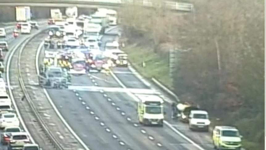 Essex County Fire and Rescue Service and National Highways Traffic Officers are on the M11. They are blocking traffic and can be seen from a CCTV motorway camera.