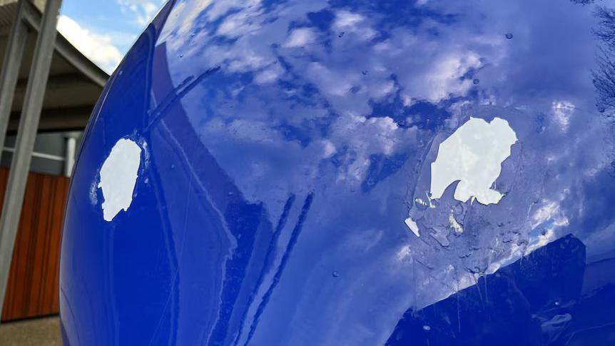 Blue sculpture with two large white patches