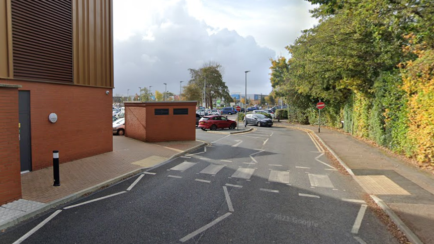 A zebra crossing in Hawthorn Road, approaching a large car park