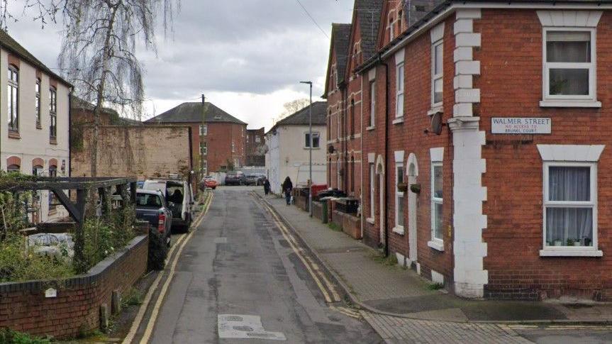 Generic view of a street with red-brick houses.