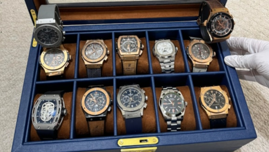 A blue leather watch box containing twelve luxury watches worth over £500,000 if authentic.