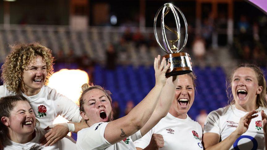 Captain Marlie Packer of England celebrates with the WXV1 trophy after victory in Auckland