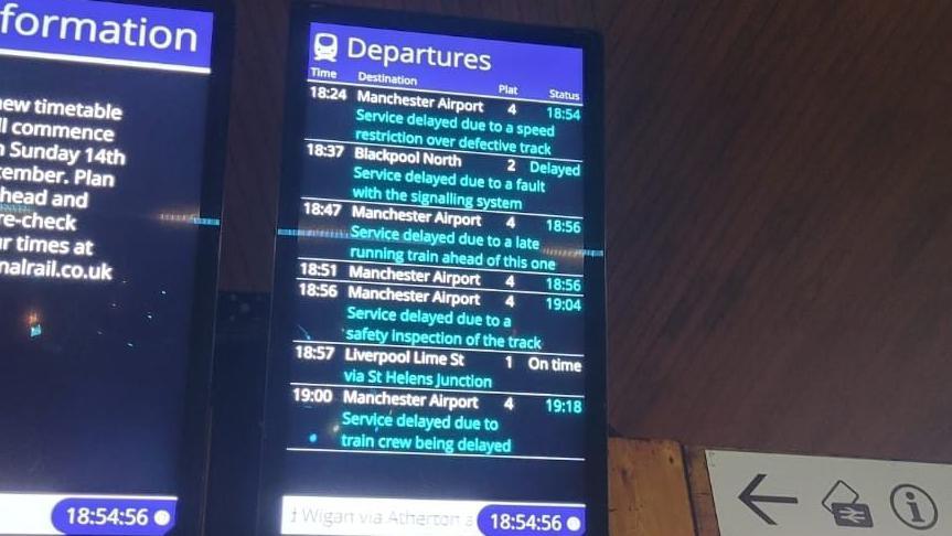 An image of a departures board at a train station. It shows multiple services are delayed due to a signally fault or a speed restriction over defective track. 