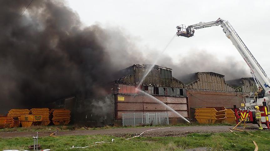 An aerial appliance being used by firefighters to pour water onto a fire at the NWR waste plant in 2021.