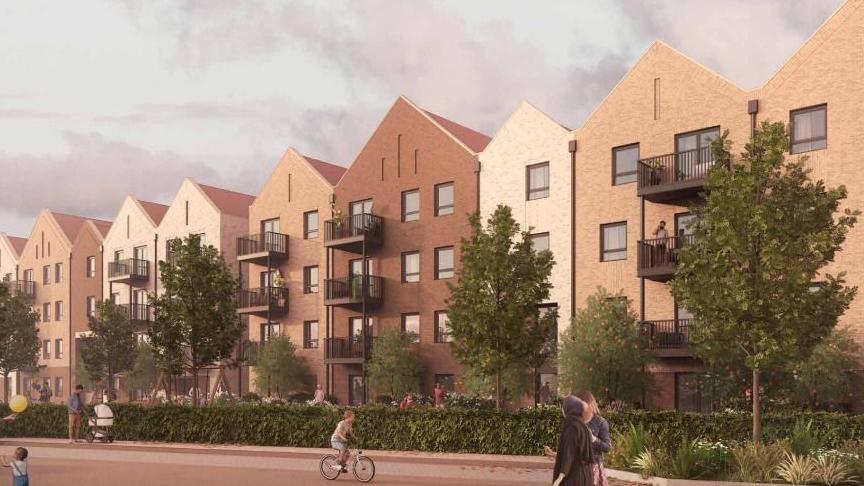 A computer generated image of the four storey apartment blocks which are going to be built in Guildford, Surrey. The apartments are differently coloured and have pointed roofs, and are also flanked by trees and bushes. 