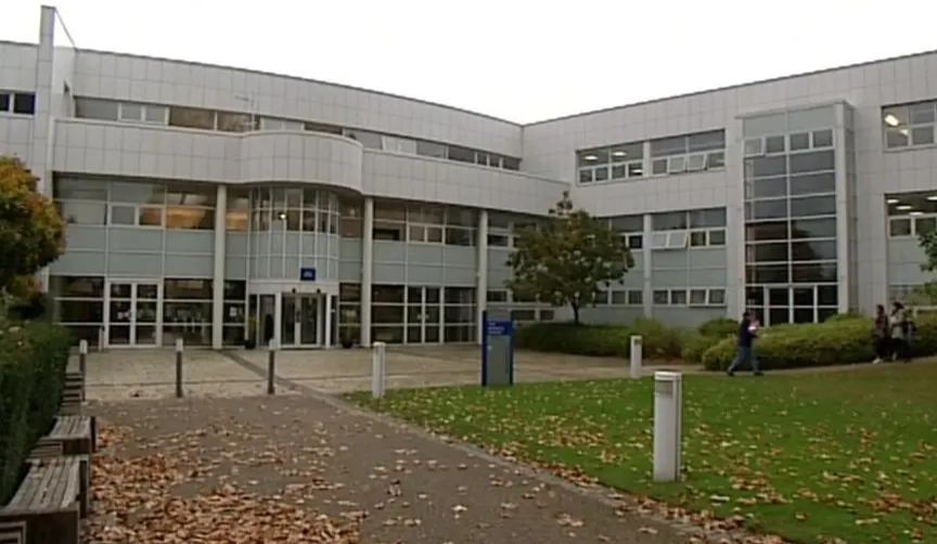 The university of Gloucestershire building, with students walking away from the building. 