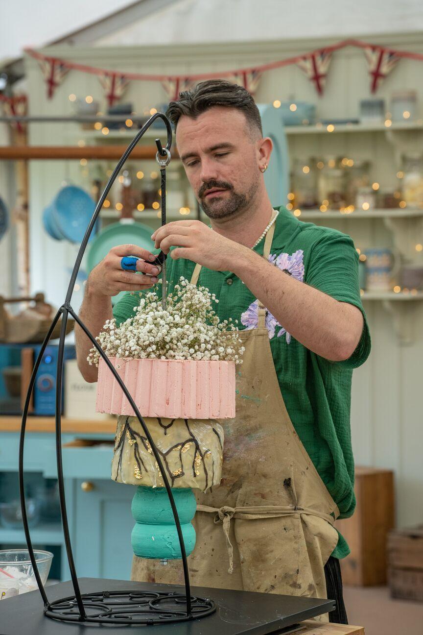 Christiaan from series 15 of the Great British Bake Off with his cake. 