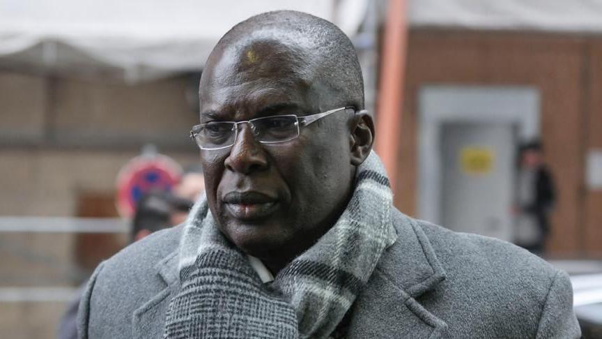 Former Nigeria’s petroleum minister Timipre Sylva wearing a coat, neck scarf and glasses