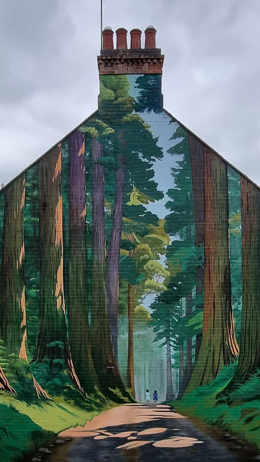 Gable end of house with a forest mural