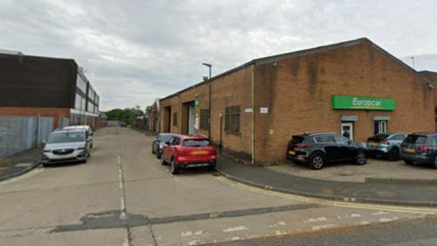 A shot of one level buildings on both sides of the street 