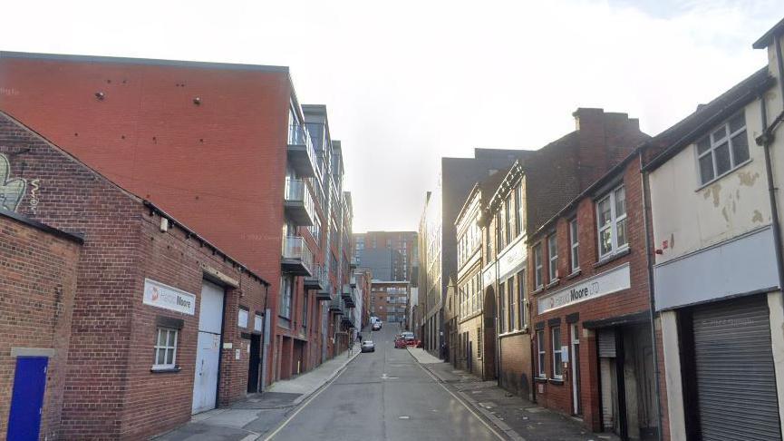 A Street View image of Bailey Street, with red-brick buildings on either side of the road.