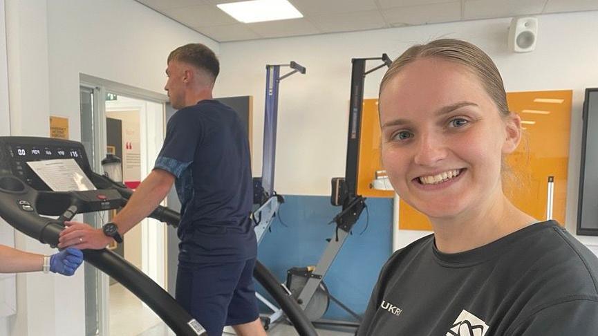 Alice Kemp stood with Derby County midfielder Ben Osborn