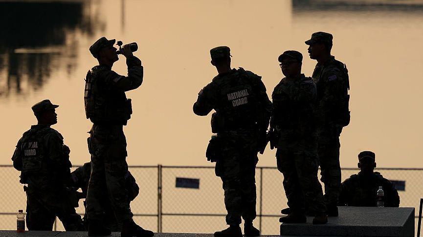 Members of the Army National Guard congregate near the Lincoln Memorial Reflecting Pool