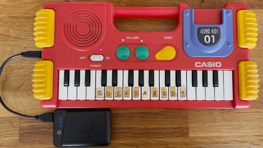 A homemade power bank charging a mini keyboard