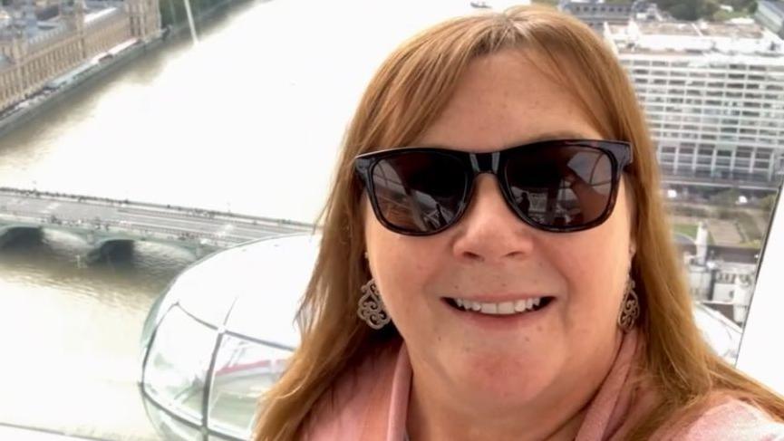 Wendy Pinch is seen in a selfie taken from high up in the London Eye. Landmarks such as the Palace of Westminster and the River Thames are visible in the background.