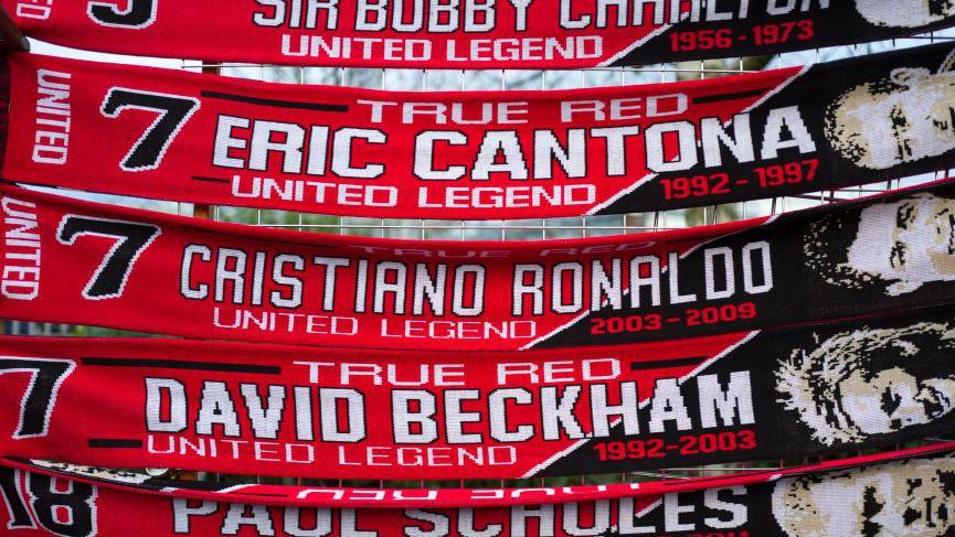 Manchester United scarves celebrating Eric Cantona, Cristiano Ronaldo and David Beckham
