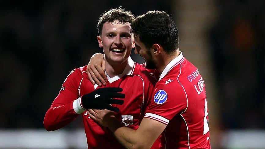 Wrexham forward Nathan Broadhead (L) celebrates with Ryan Longman