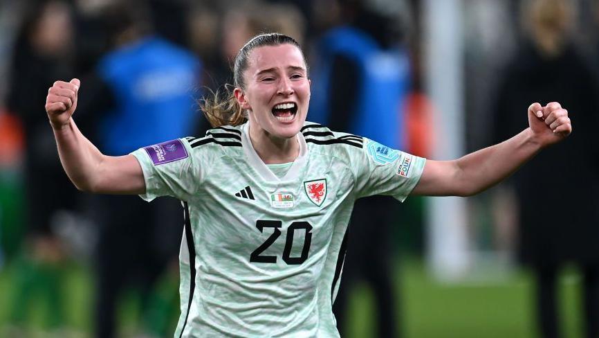 Carrie Jones celebrates while playing for Wales