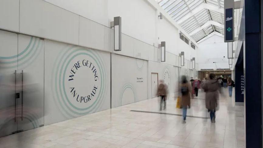 Inside the Derbion where an empty unit on the side of the wall says WE'RE GETTING AN UPGRADE.