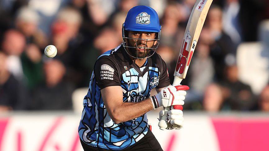 Sikandar Raza watches the ball fly away after playing a shot while batting for Worcestershire in a T20 game