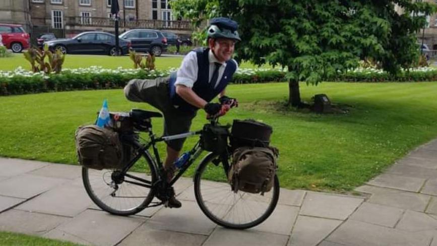 Harry Satloka on his bike carrying out his journey