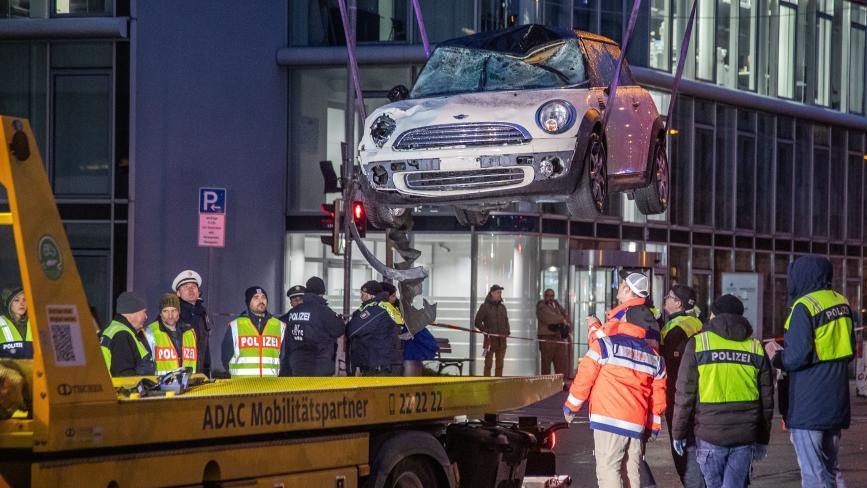 A Mini Cooper used in the Munich attack is removed from the scene