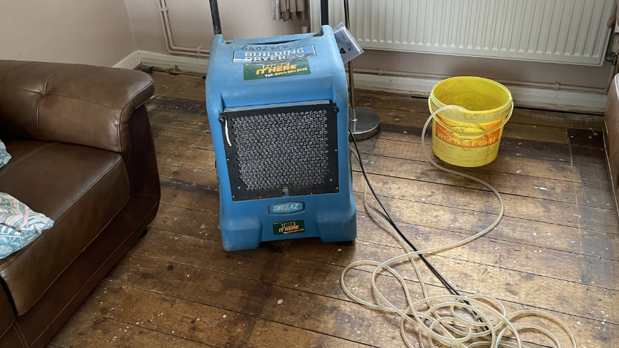 Bare damp floorboards at home of Loughborough council tenant.