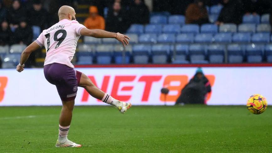 Bryan Mbeumo striking his penalty