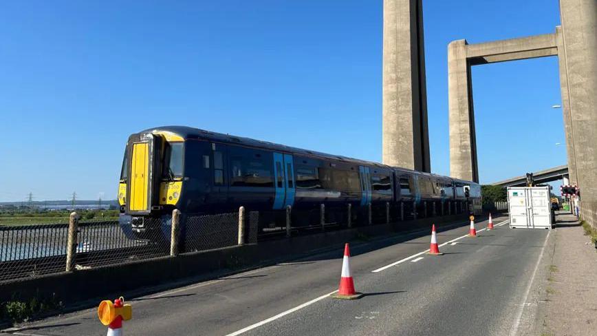 A close up shot of a Southeastern train crossing the Kingsferry bridge