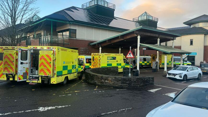 Seven ambulances outside a hospital emergency department