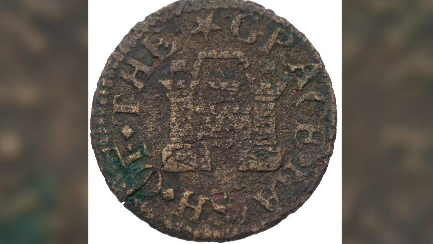 An old coin close-up: it is a very muddy copper colour and the imprint of a stylised castle can be seen in the middle with words round the edge - one of them says Grace in capitals