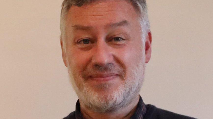 Paul McCay smiles at the camera.