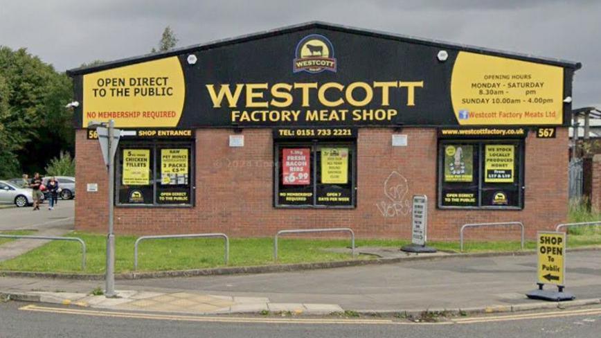 Westcott Factory Meat Shop building with large yellow and black signage.