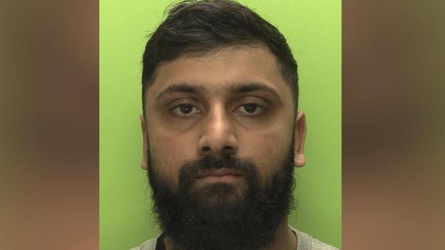A police custody shot of Hesaam Ghori
