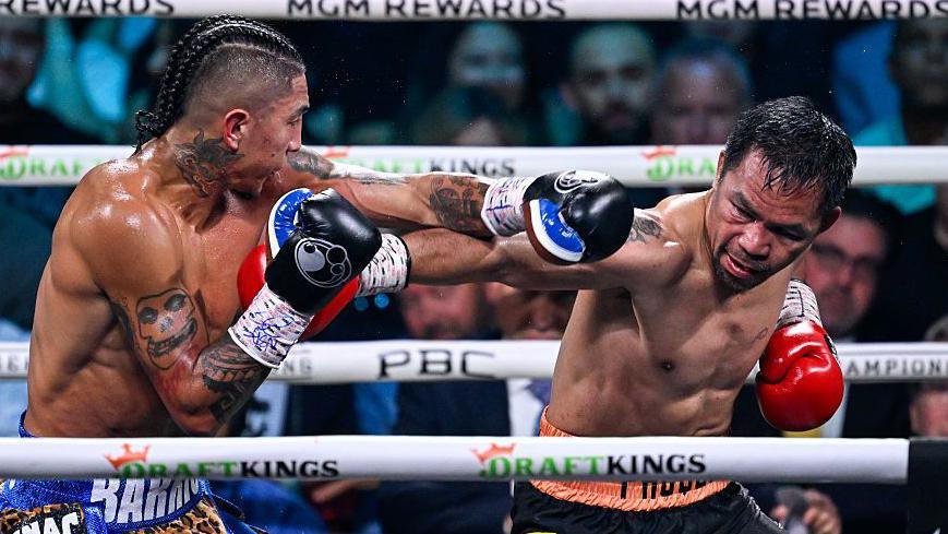 Mario Barrios is punched by Manny Pacquiao
