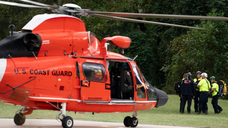 A US Coast Guard helicopter lands near Davistown, North Carolina in the aftermath of Hurricane Helene