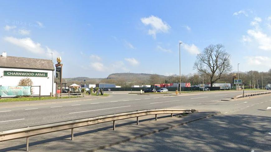A road with a pub in the background and blue skies above