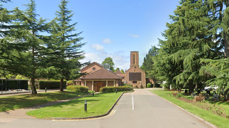 Canley Crematorium a large red brick building, surrounded by large trees and grass verges