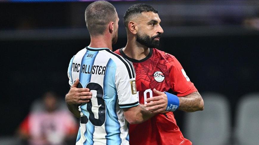 Egypt's Mohamed Salah embraces his former Liverpool team-mate Alexis Mac Allister after full-time in the World Cup last-16 match with Argentina