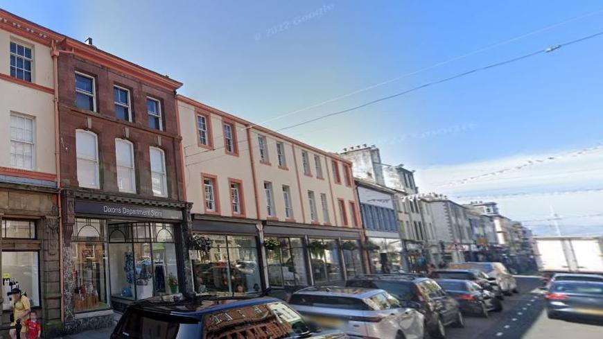 A general view of Dixons Department Store in Whitehaven. There are four window displays across as may buildings to the right of the main entrance and more can be seen on the left. 