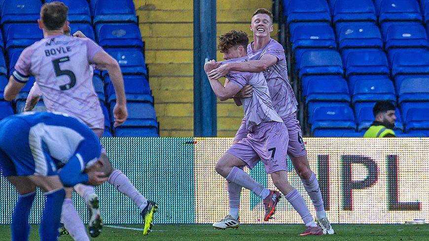 Tommy McDermott is grabbed by a team-mate in celebration after scoring what they thought was a last-minute winner against Oldham