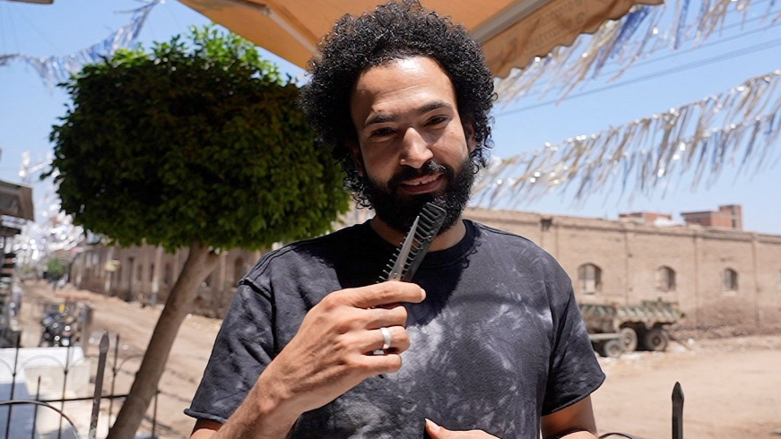 Ahmed El Masri, the barber who used to cut Salah's hair, outside his shop in Nagrig