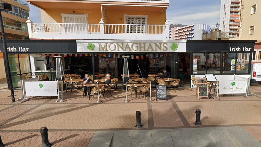 A general view of Monaghans Bar with the name of the pub in gold lettering on a white sign above the entrance.