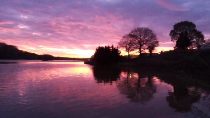 Pink skies and yellow in sky - over water  