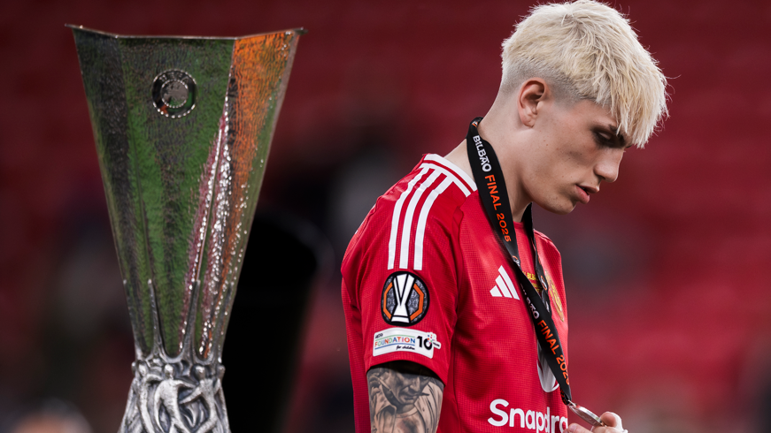 Manchester United winger Alejandro Garnacho walks past the Europa League trophy after his side's defeat to Tottenham in the final 