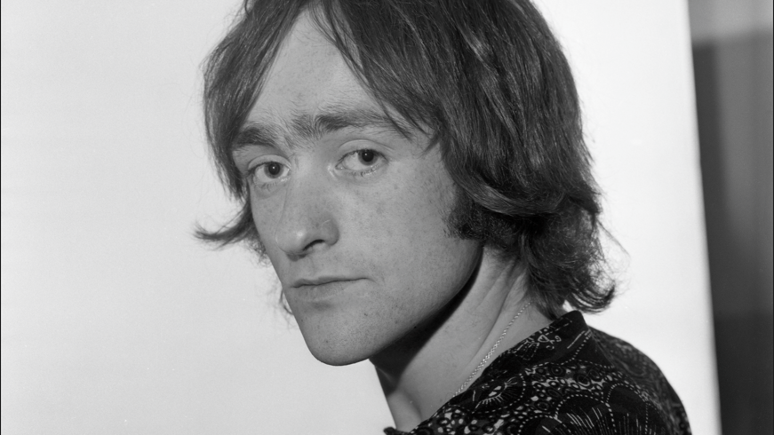 A black and white image of a young Dave Mason with shoulder length hair 