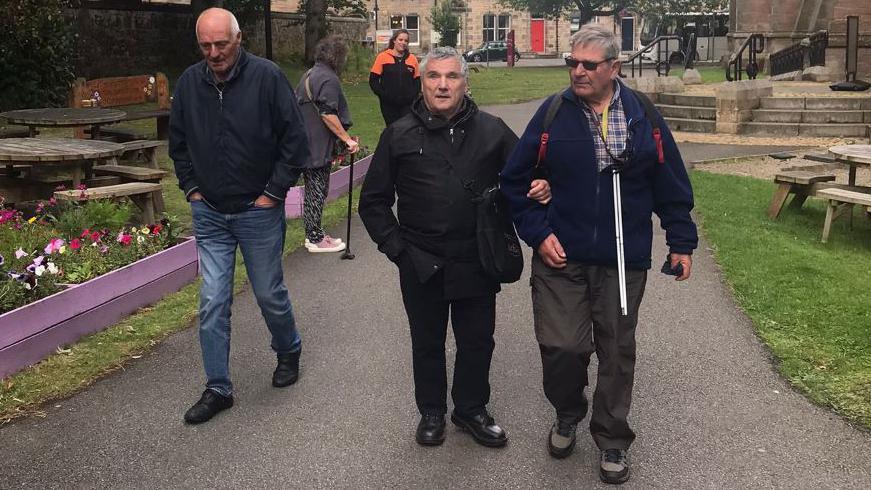 Walking group volunteer Pete Doughty with group members Evan McDonald and John Baptie at Inverness Cathedral