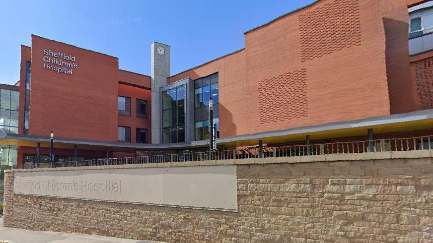 Sheffield Children's Hospital - a large red-brick building, with a clock tower between two wings