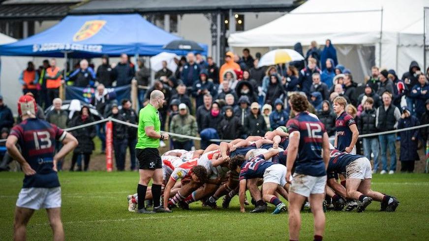 Two teams scrum down against each other at St Joseph's Rugby Festival